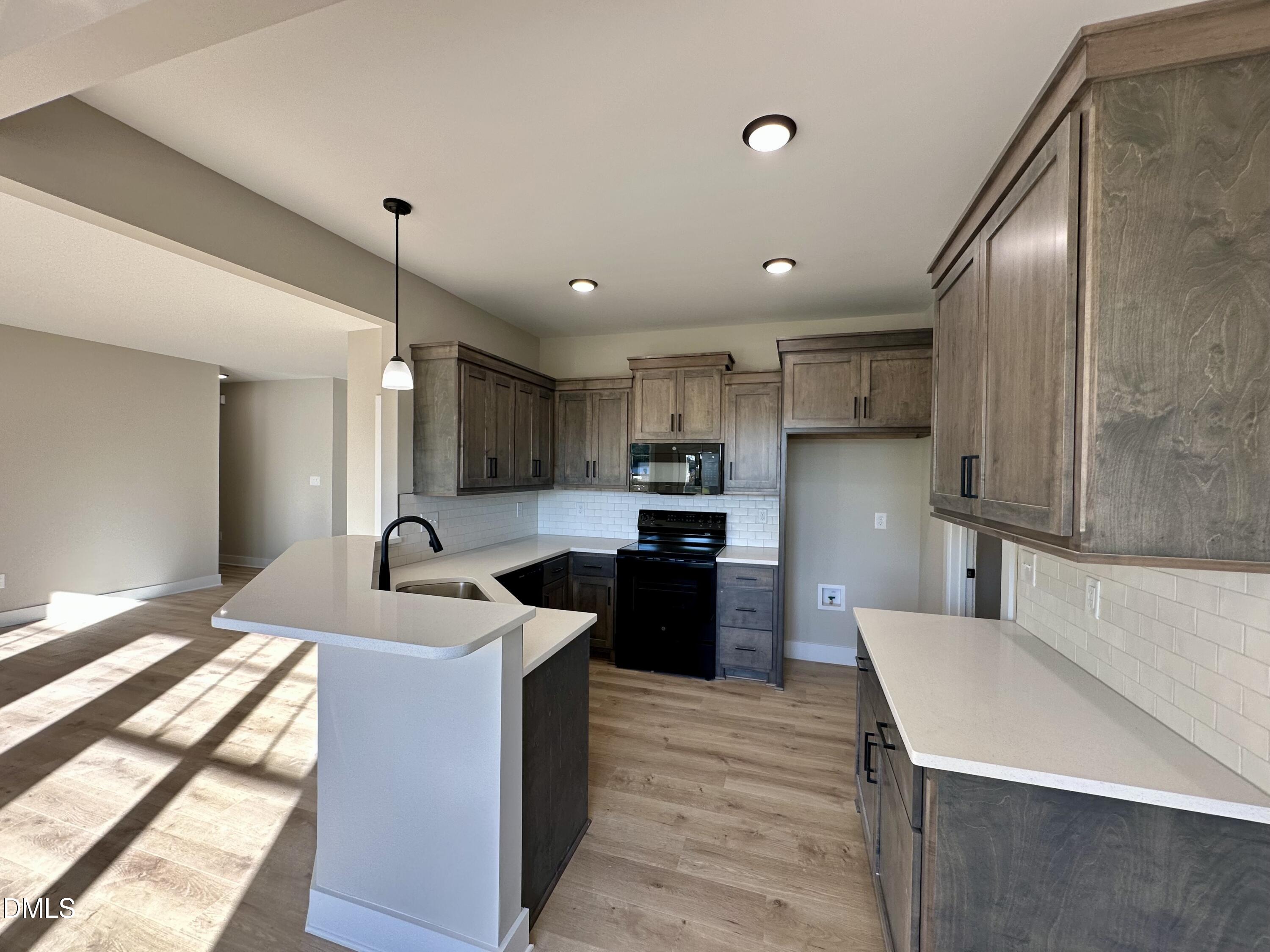 165 Bay Valley Road Kenly, NC 27542 - Photo 7 of 23 a kitchen with stainless steel appliances kitchen island granite countertop a sink refrigerator and cabinets