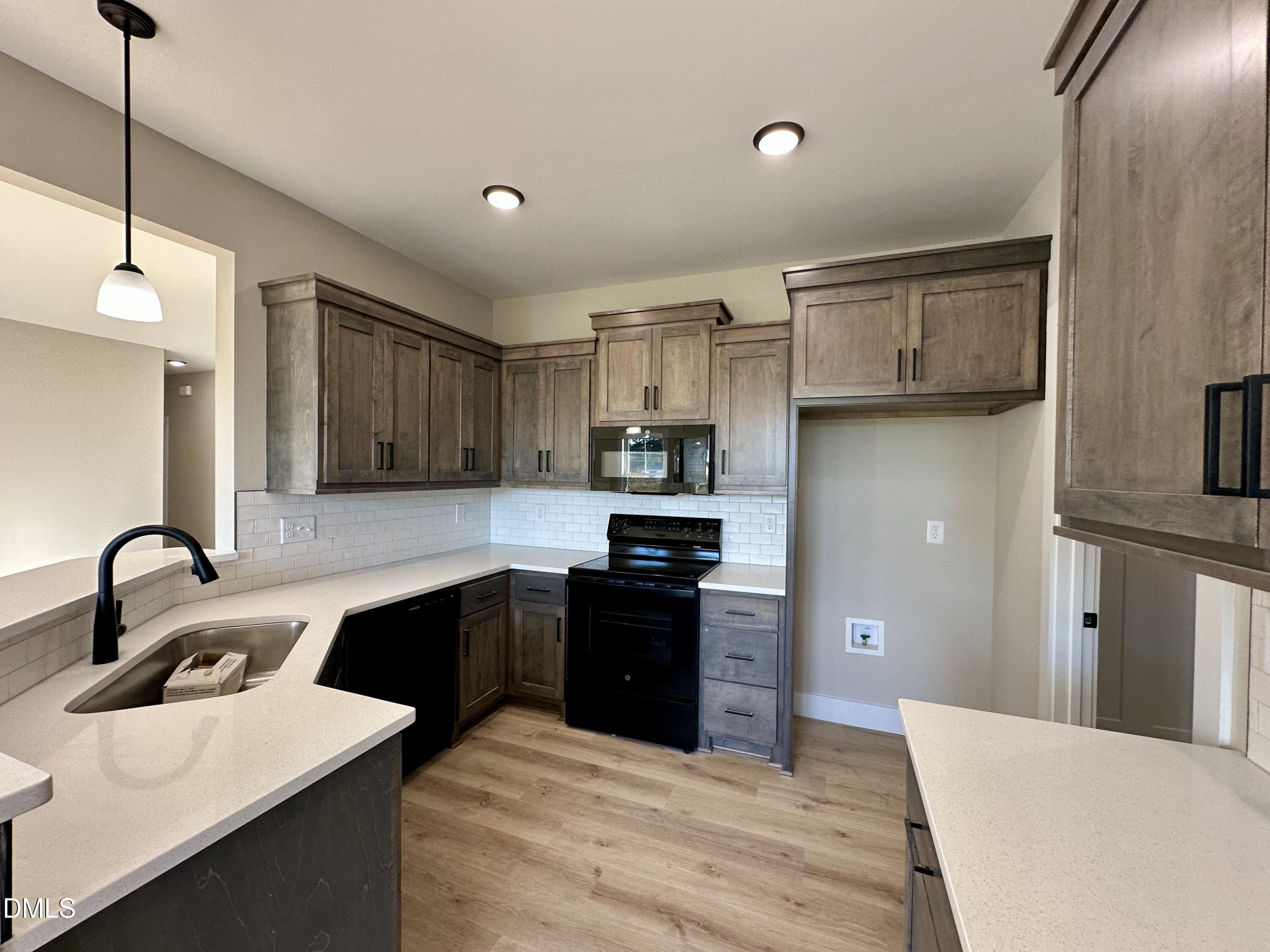 165 Bay Valley Road Kenly, NC 27542 - Photo 8 of 23 a kitchen with stainless steel appliances granite countertop a sink stove and refrigerator
