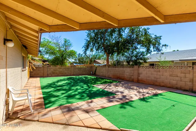 a view of a house with a yard and sitting area