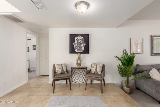 a dining room with furniture a rug and a chandelier