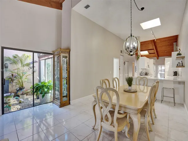 a view of a dining room with furniture wooden floor and chandelier