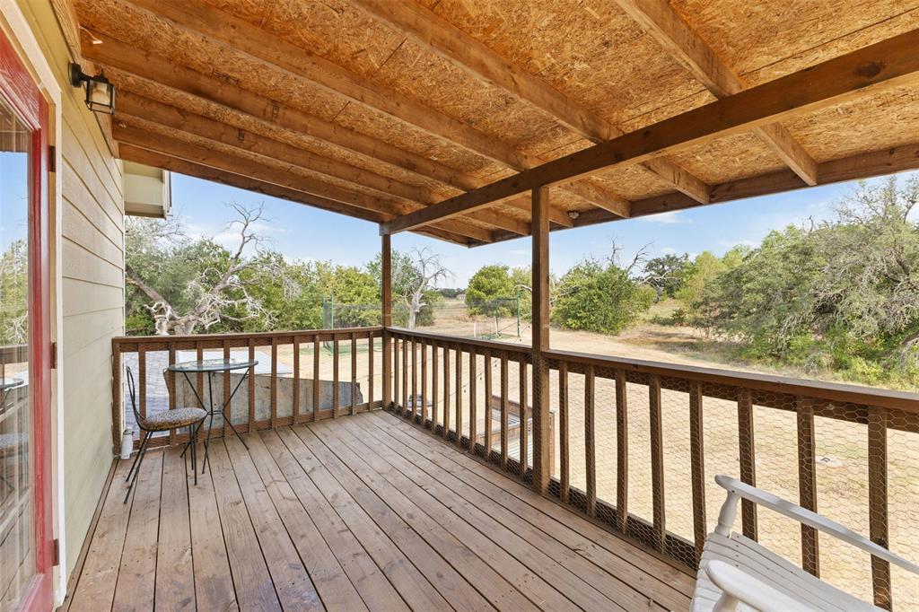 325 Bolton Road Granbury, TX 76049 - Photo 30 of 39 Expansive covered wood deck with wood-plank flooring and a wooden railing