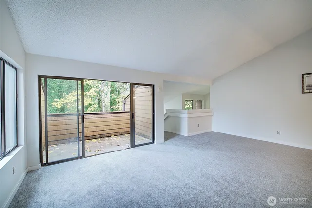 an empty room with a fireplace and cabinet
