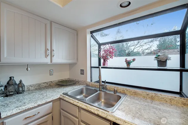 a view of bathroom with a shower and closet