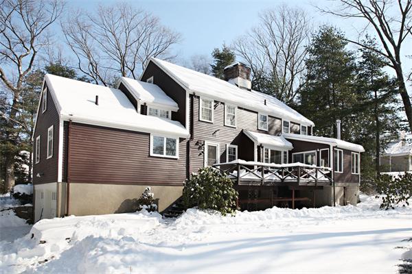 34 Wachusett Road Wellesley, MA 02481 - Photo 2 of 4 a view of a white house with snow on the road