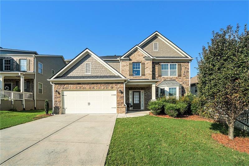 566 Olympic Way Acworth, GA 30102 - Photo 1 of 38 a front view of a house with a yard and garage