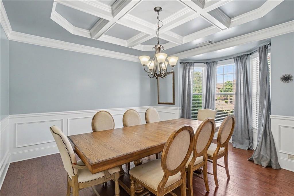 566 Olympic Way Acworth, GA 30102 - Photo 15 of 38 a view of a dining room with furniture a chandelier and wooden floor
