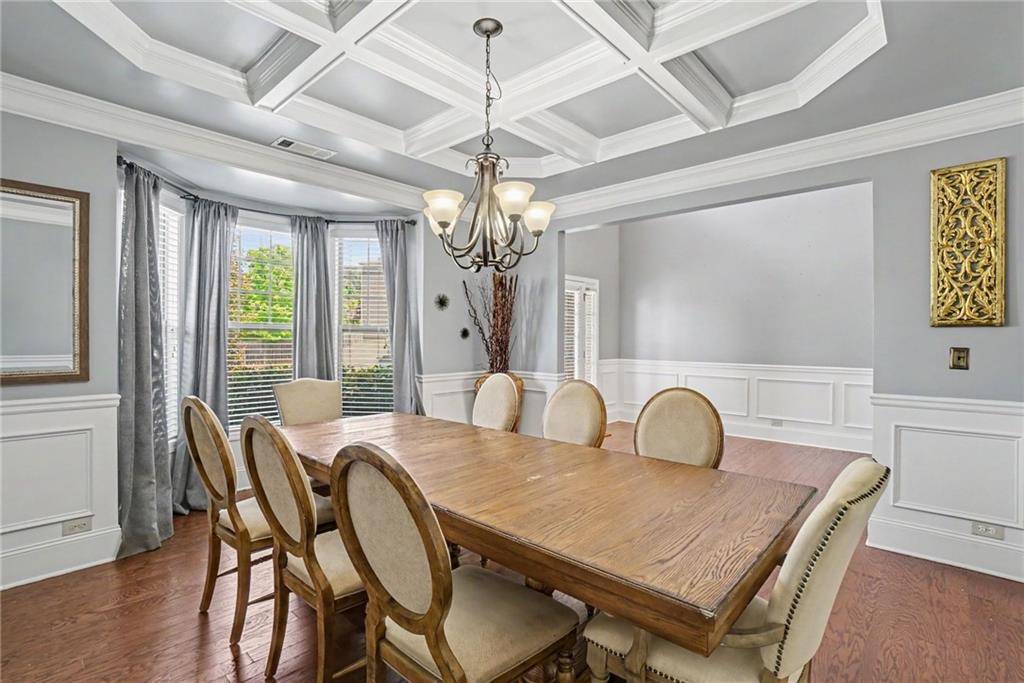 566 Olympic Way Acworth, GA 30102 - Photo 16 of 38 a dining room with furniture a chandelier and wooden floor
