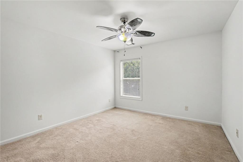 566 Olympic Way Acworth, GA 30102 - Photo 22 of 38 an empty room with a window and a fan