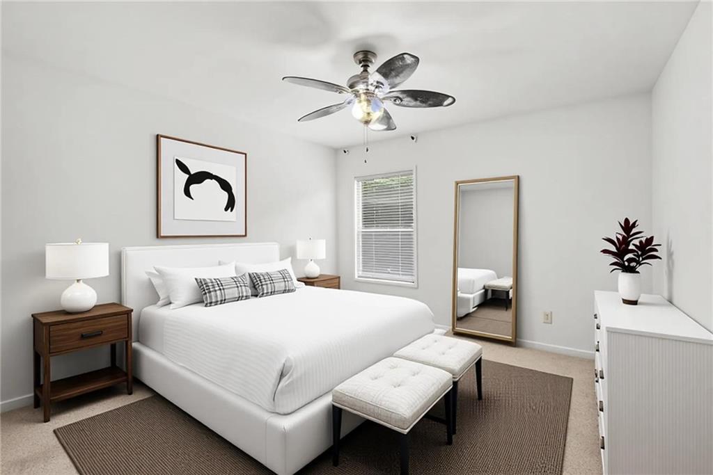 566 Olympic Way Acworth, GA 30102 - Photo 25 of 38 a bedroom with a bed and a chandelier