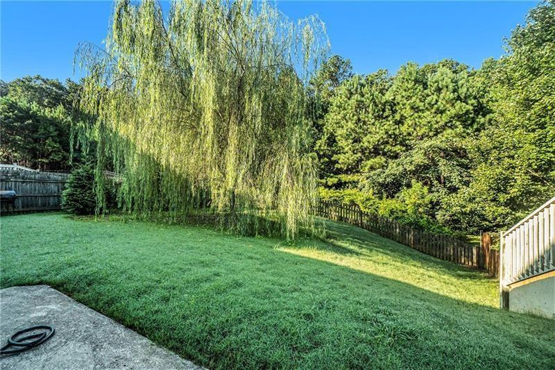 566 Olympic Way Acworth, GA 30102 - Photo 4 of 38 a view of a backyard with a garden