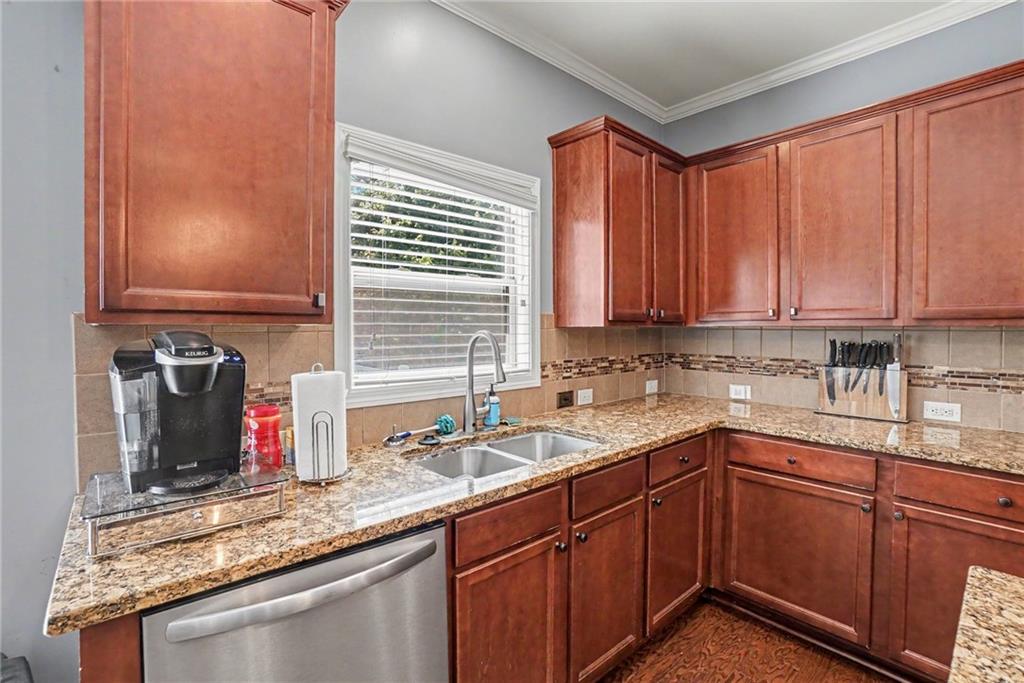 566 Olympic Way Acworth, GA 30102 - Photo 10 of 38 a kitchen with stainless steel appliances granite countertop a sink a stove and cabinets