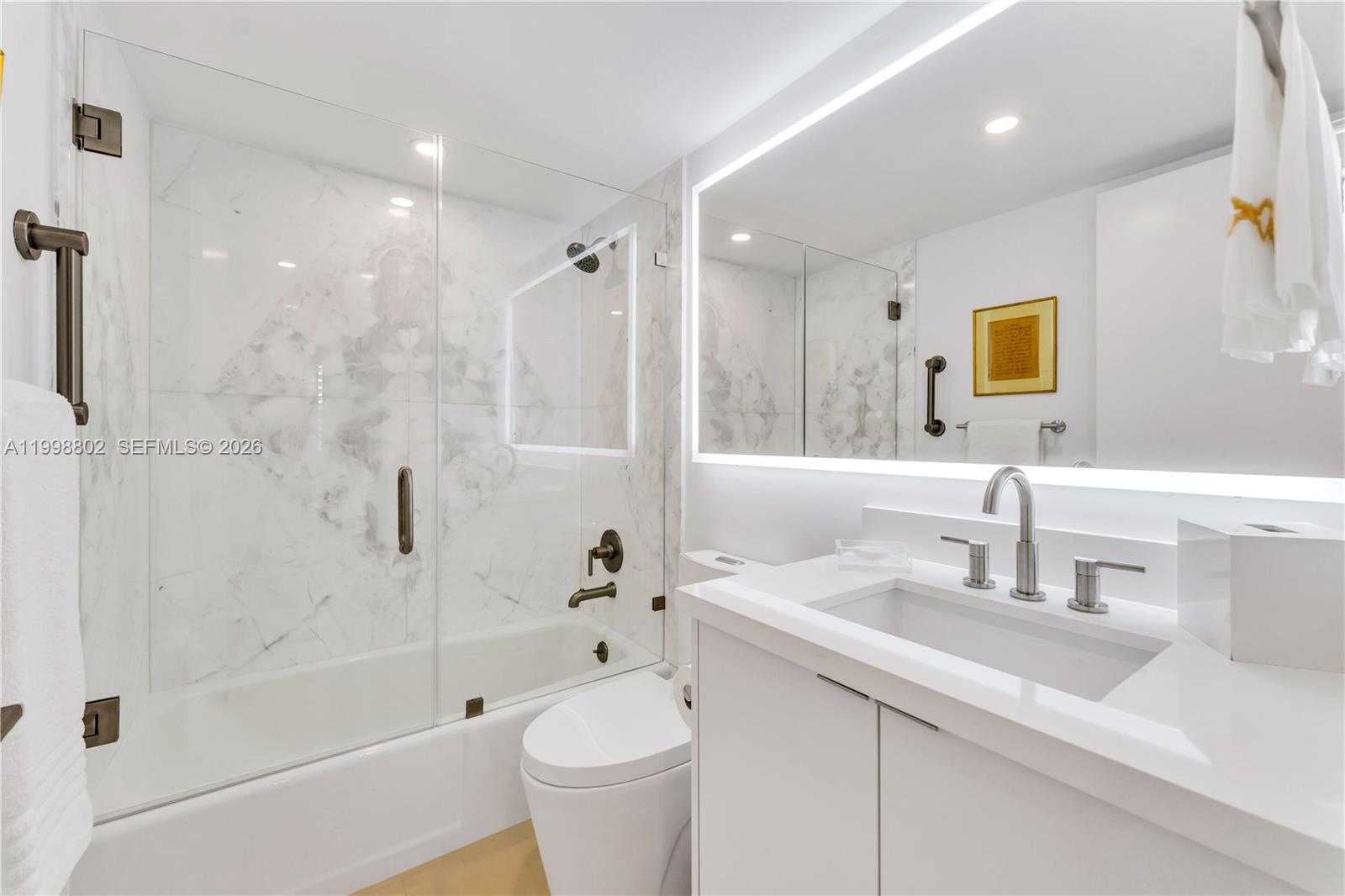 199 Ocean Ln Drive, Unit 306 Key Biscayne, FL 33149 - Photo 12 of 15 a bathroom with a sink a toilet and shower