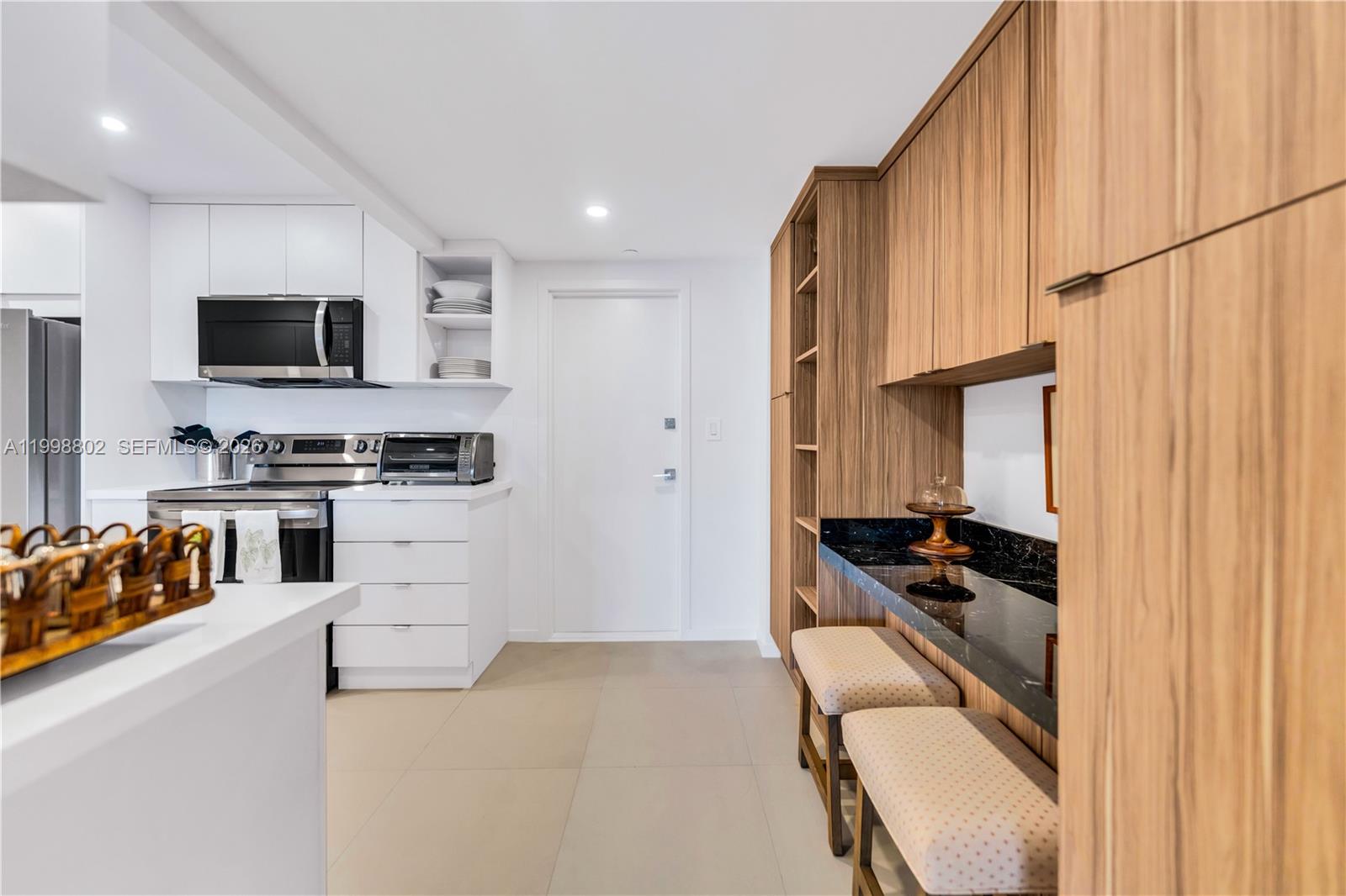 199 Ocean Ln Drive, Unit 306 Key Biscayne, FL 33149 - Photo 5 of 15 a kitchen with stainless steel appliances a stove a microwave and a refrigerator