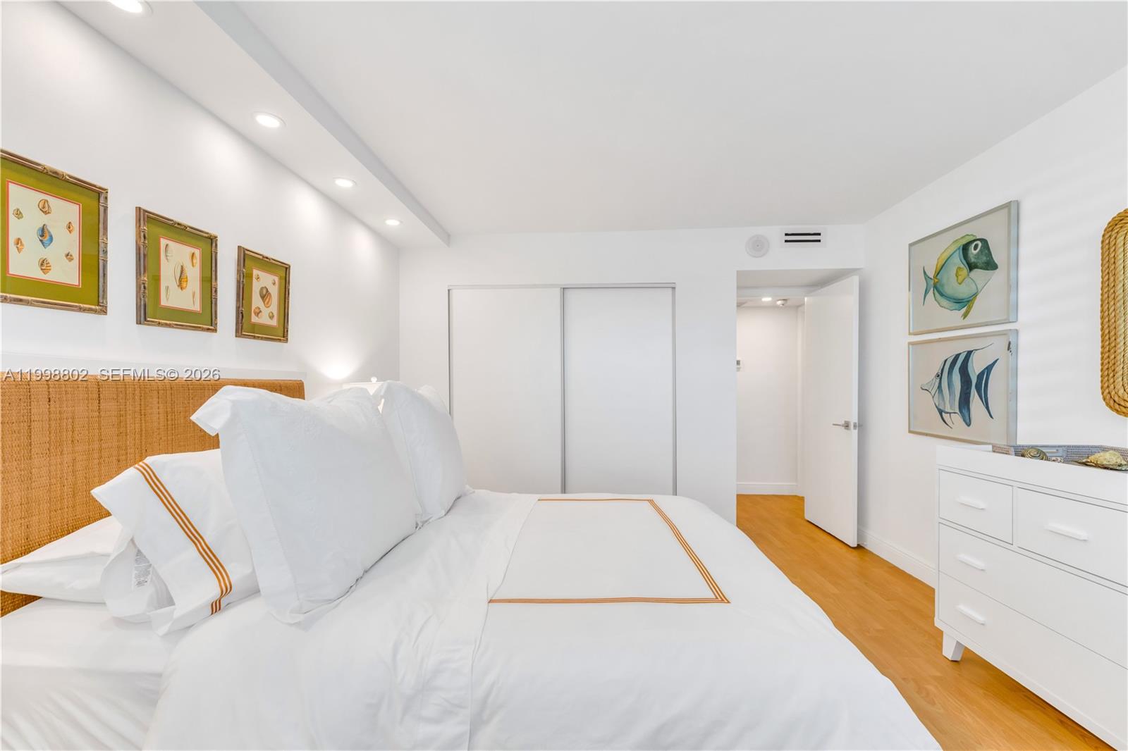 199 Ocean Ln Drive, Unit 306 Key Biscayne, FL 33149 - Photo 7 of 15 a bedroom with a bed and painting on the wall