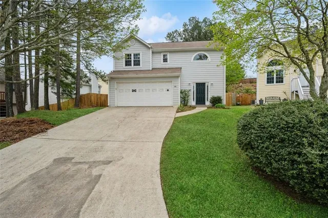 a front view of house with a garden