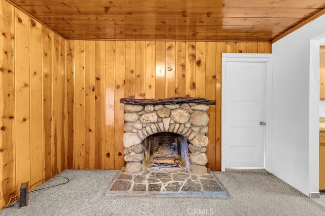 a living room with a fireplace furniture and a wooden floor