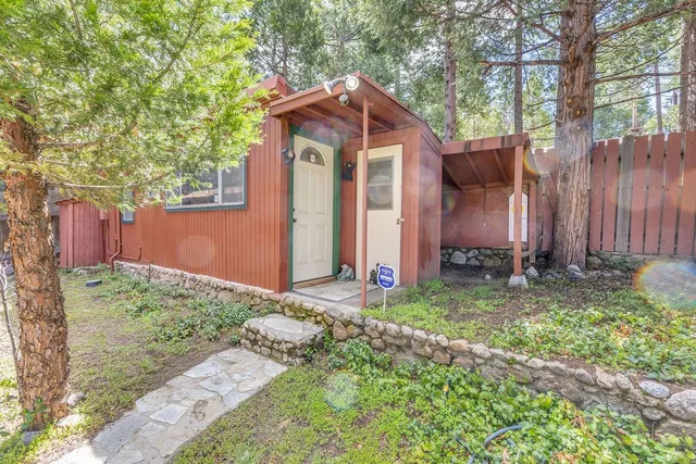 a view of an empty room with closet and a fireplace