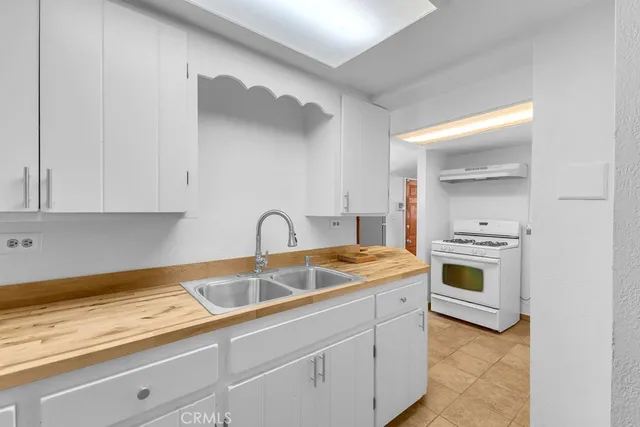 a kitchen with a sink cabinets and stainless steel appliances