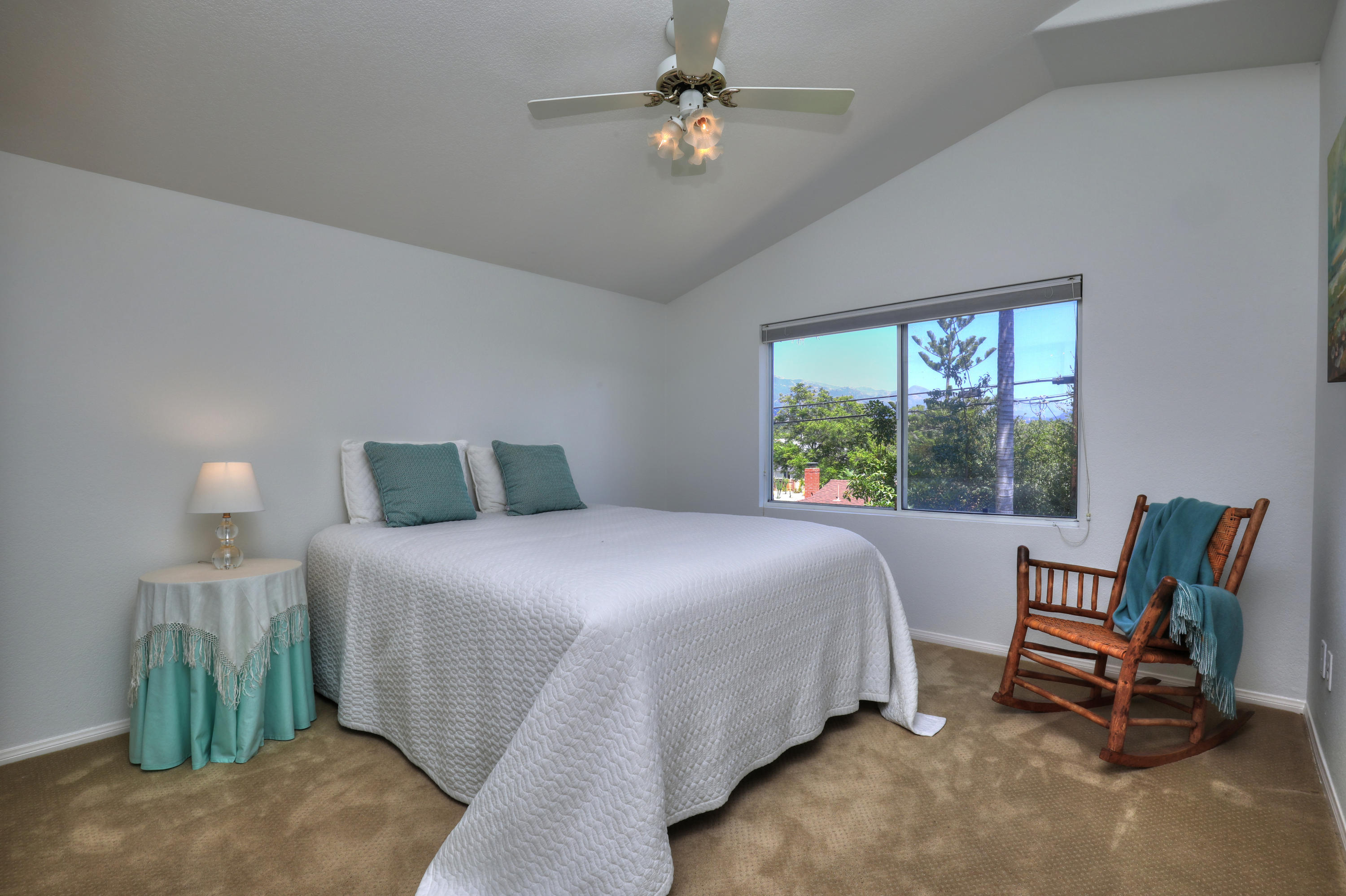 3713 Hitchcock Ranch Road Santa Barbara, CA 93105 - Photo 23 of 28 a bedroom with a bed a chair and a chandelier