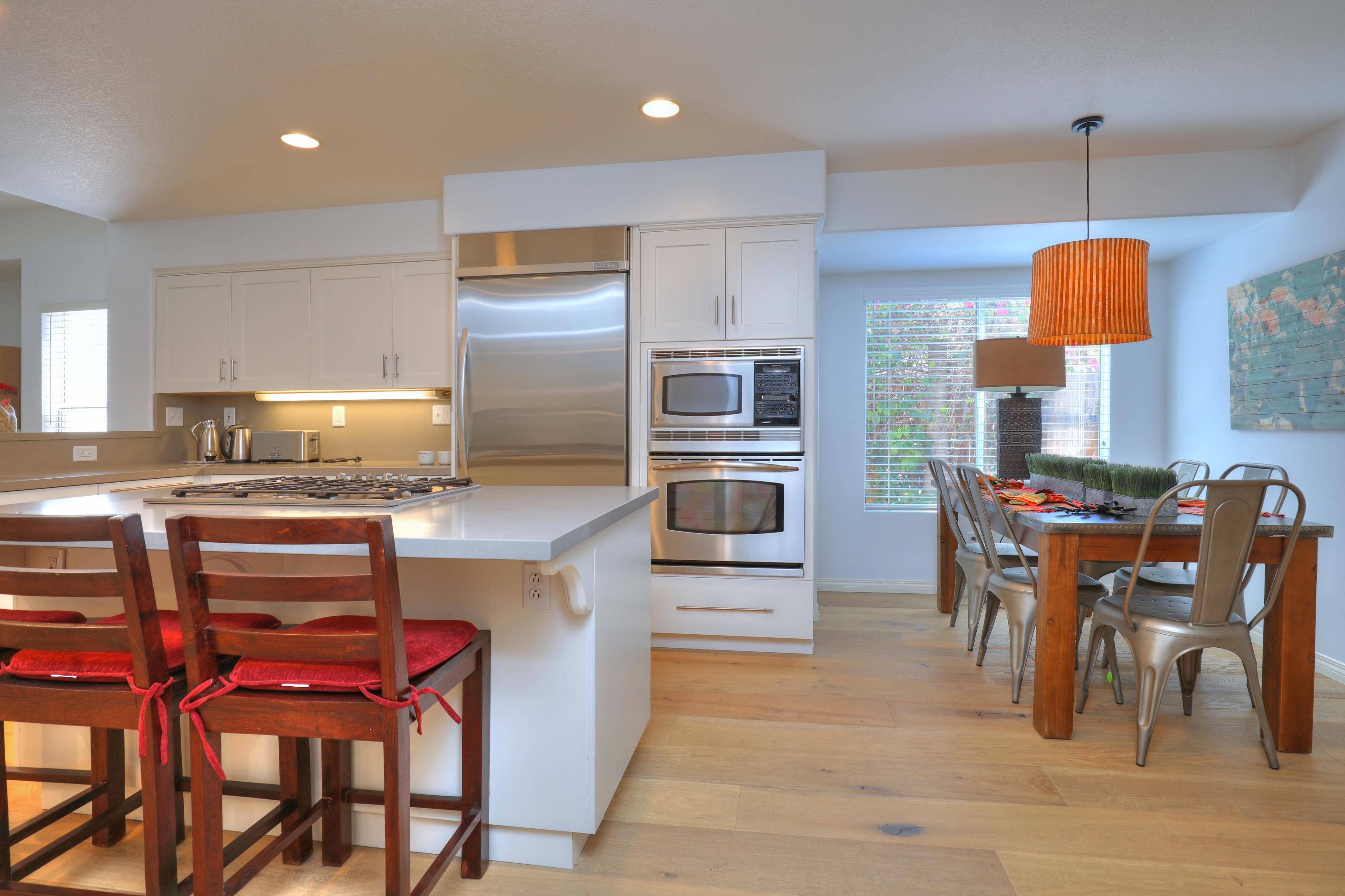 3713 Hitchcock Ranch Road Santa Barbara, CA 93105 - Photo 8 of 28 a kitchen with stainless steel appliances kitchen island granite countertop a table chairs and a refrigerator