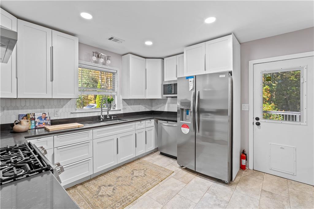2150 Azalea Circle Decatur, GA 30033 - Photo 6 of 28 a kitchen with stainless steel appliances granite countertop a refrigerator and a sink