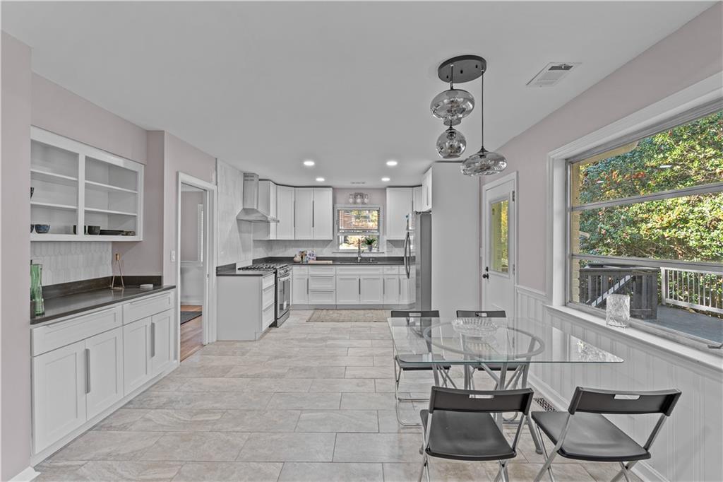 2150 Azalea Circle Decatur, GA 30033 - Photo 7 of 28 a kitchen with stainless steel appliances granite countertop a stove top oven a sink a dining table and chairs