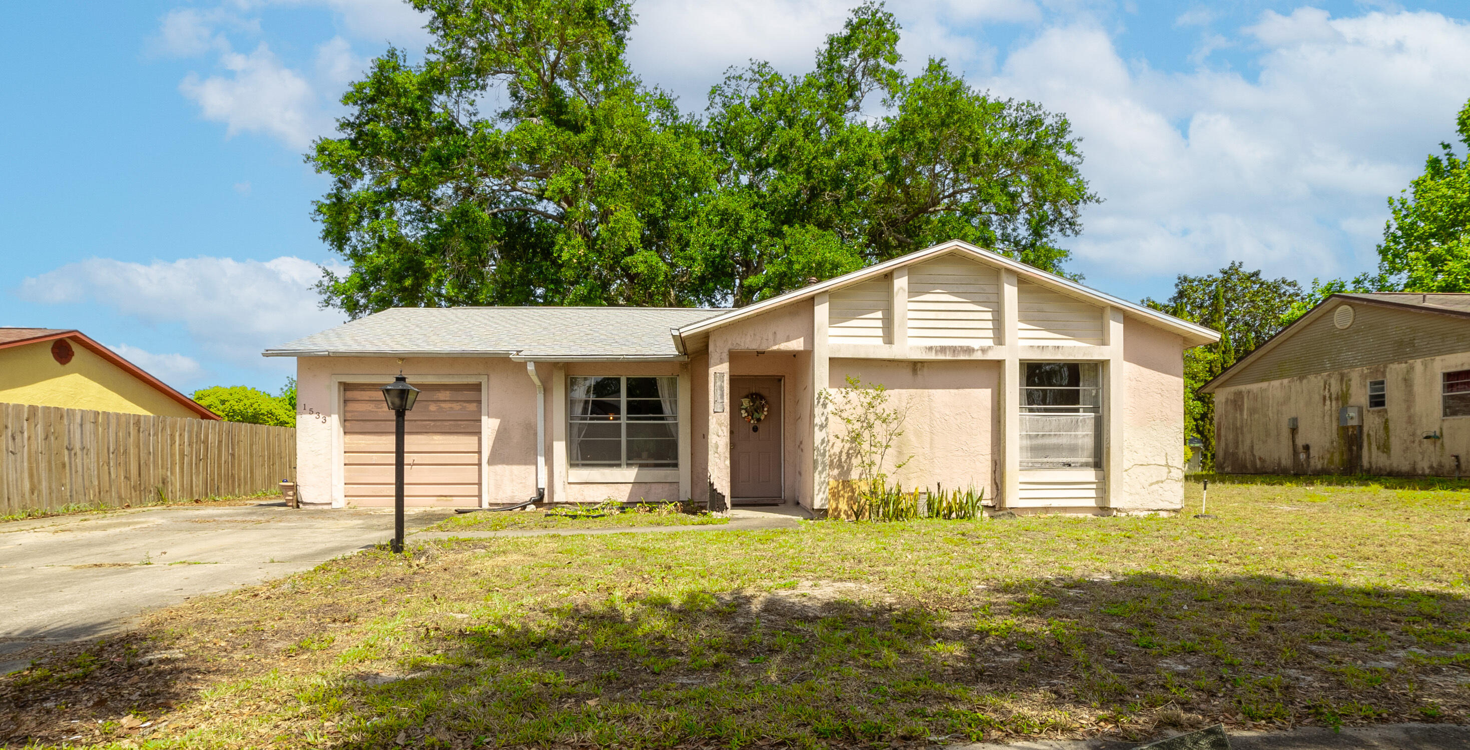 1533 West Powder Horn Road Titusville, FL 32796 - Photo 1 of 29 a front view of a house with a yard