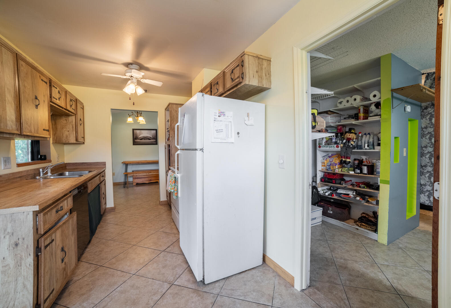 1533 West Powder Horn Road Titusville, FL 32796 - Photo 11 of 29 a kitchen with refrigerator and cabinets