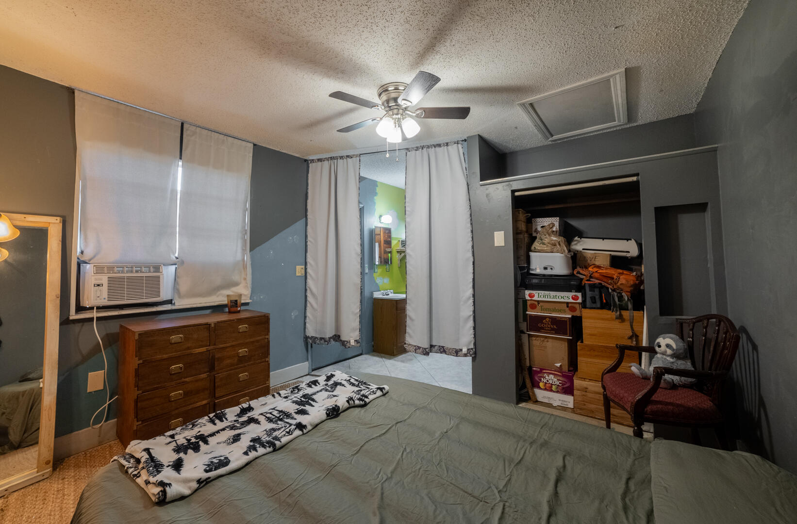 1533 West Powder Horn Road Titusville, FL 32796 - Photo 16 of 29 a bedroom with a bed and a chandelier