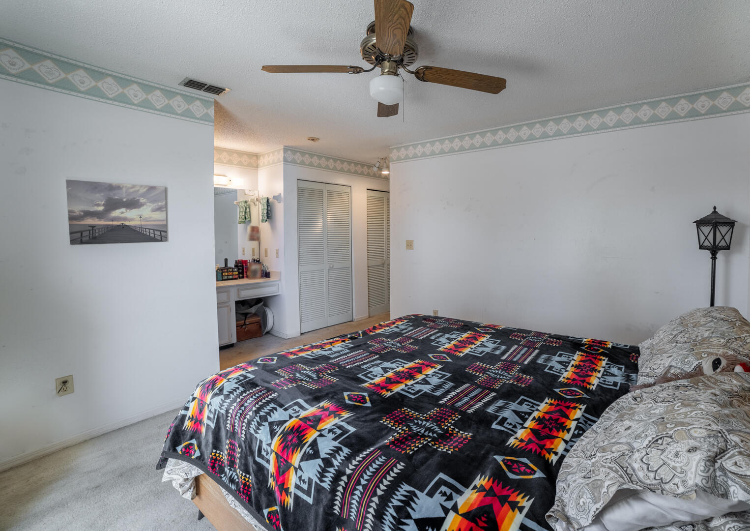 1533 West Powder Horn Road Titusville, FL 32796 - Photo 19 of 29 a bedroom with a bed and a chandelier