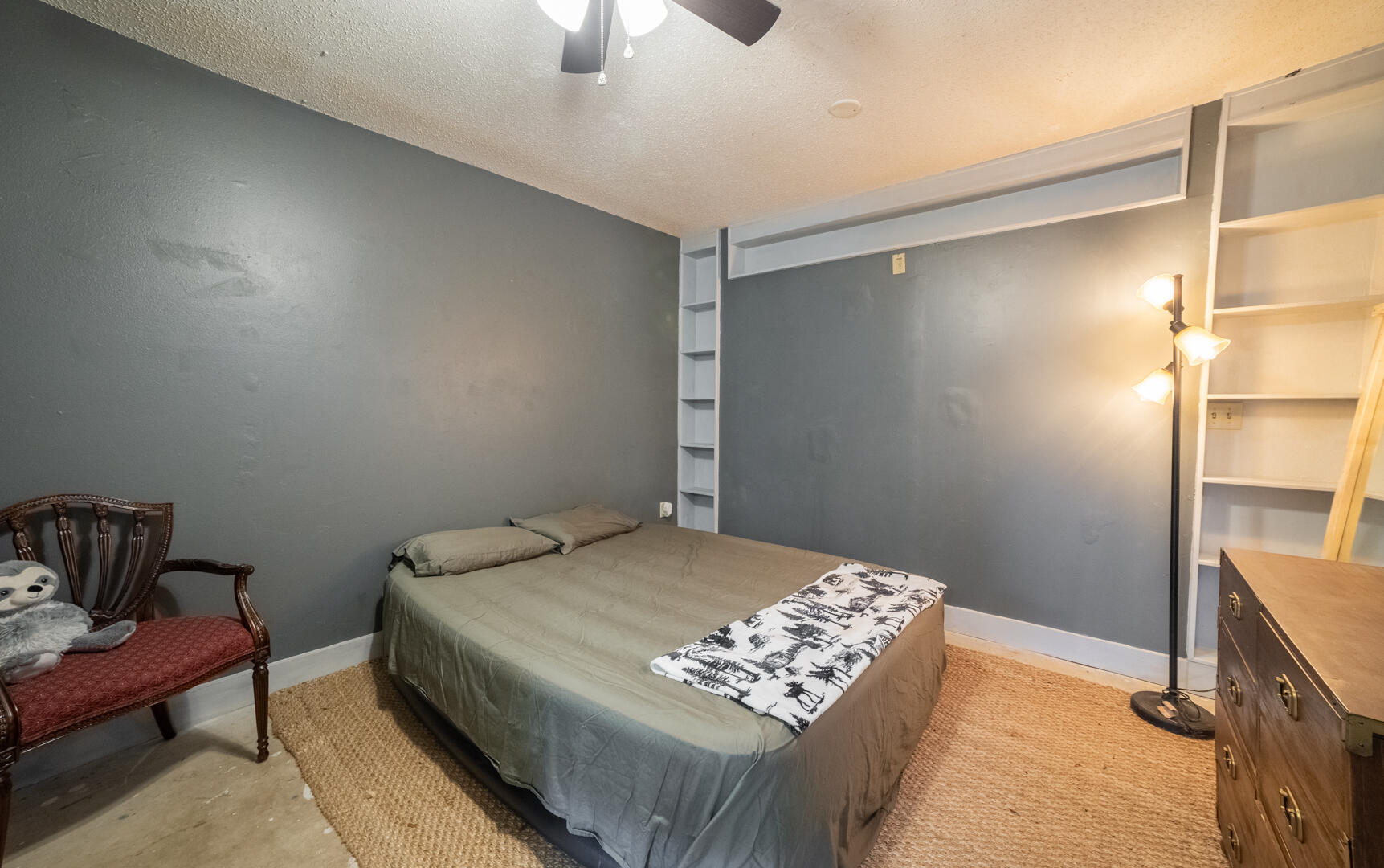 1533 West Powder Horn Road Titusville, FL 32796 - Photo 22 of 29 a bedroom with a bed and a table in it