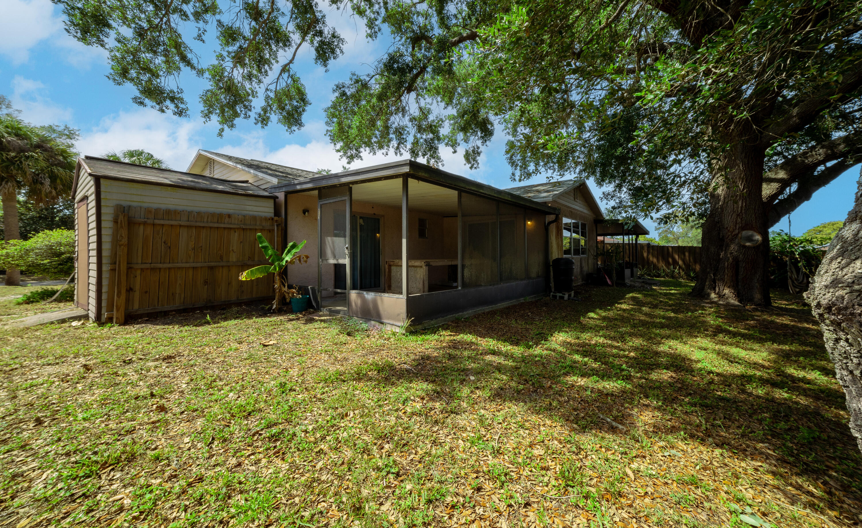 1533 West Powder Horn Road Titusville, FL 32796 - Photo 23 of 29 a backyard of a house with a garden and barbeque oven