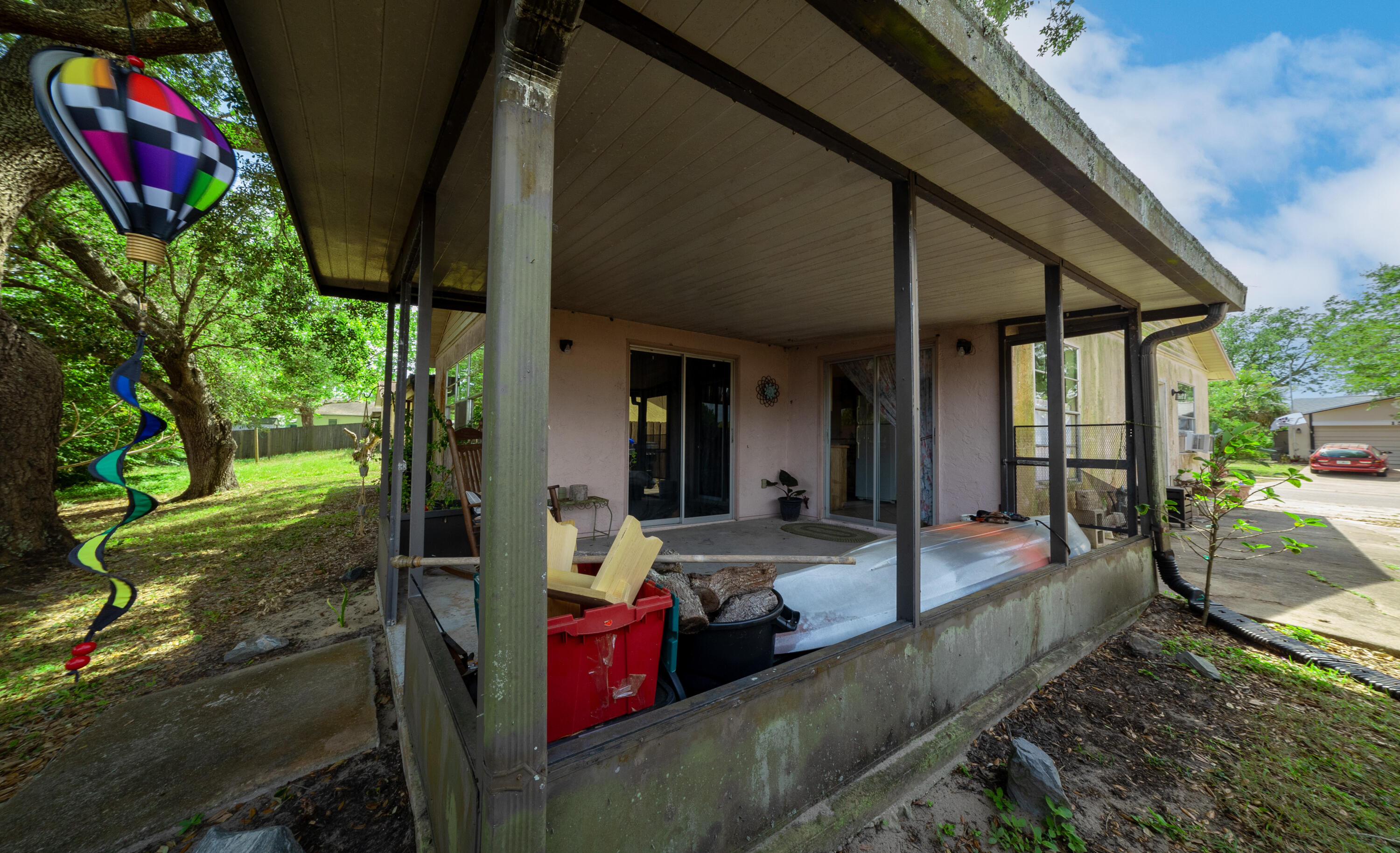 1533 West Powder Horn Road Titusville, FL 32796 - Photo 24 of 29 a view of a porch with chairs and backyard