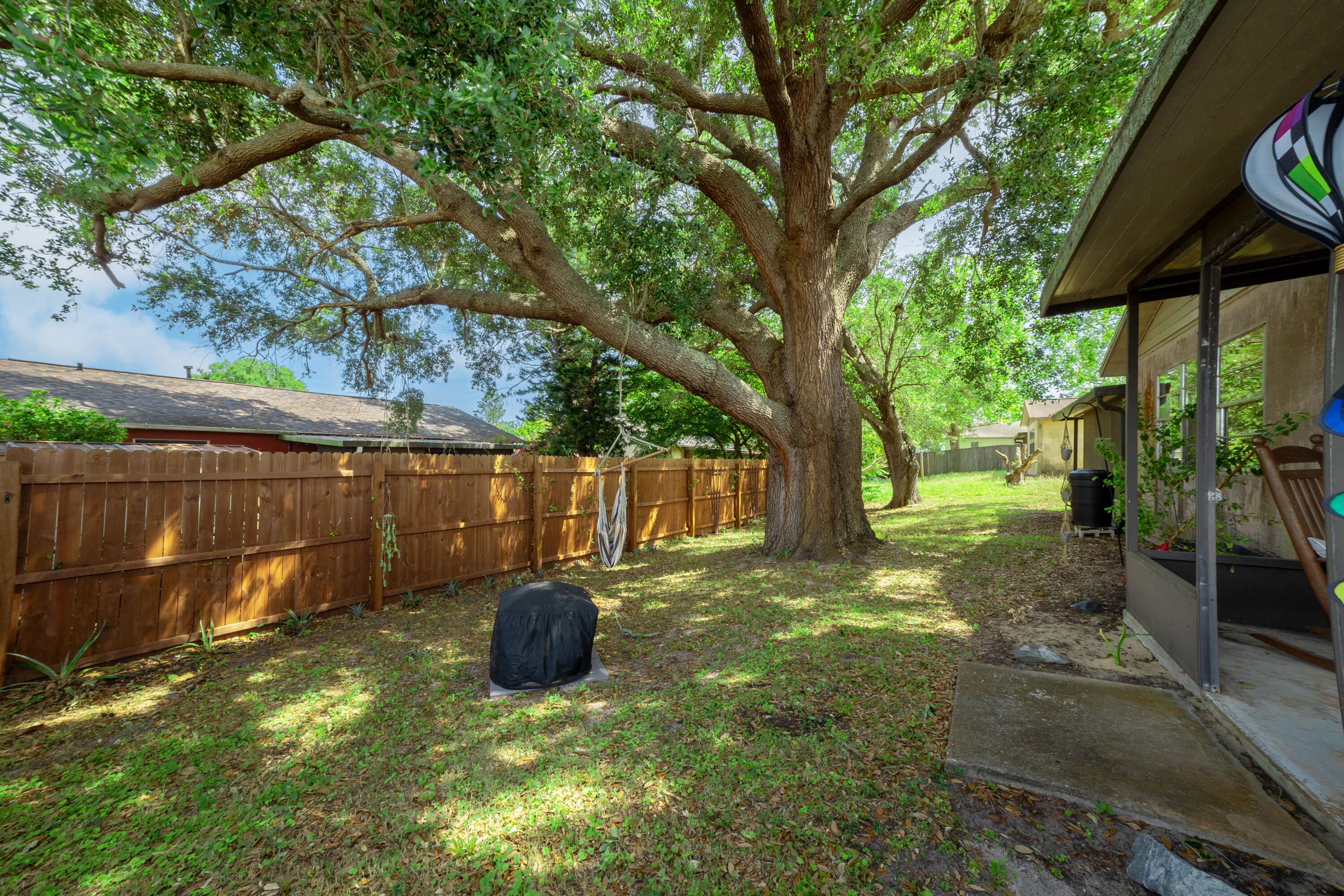 1533 West Powder Horn Road Titusville, FL 32796 - Photo 27 of 29 a backyard of a house with barbeque oven