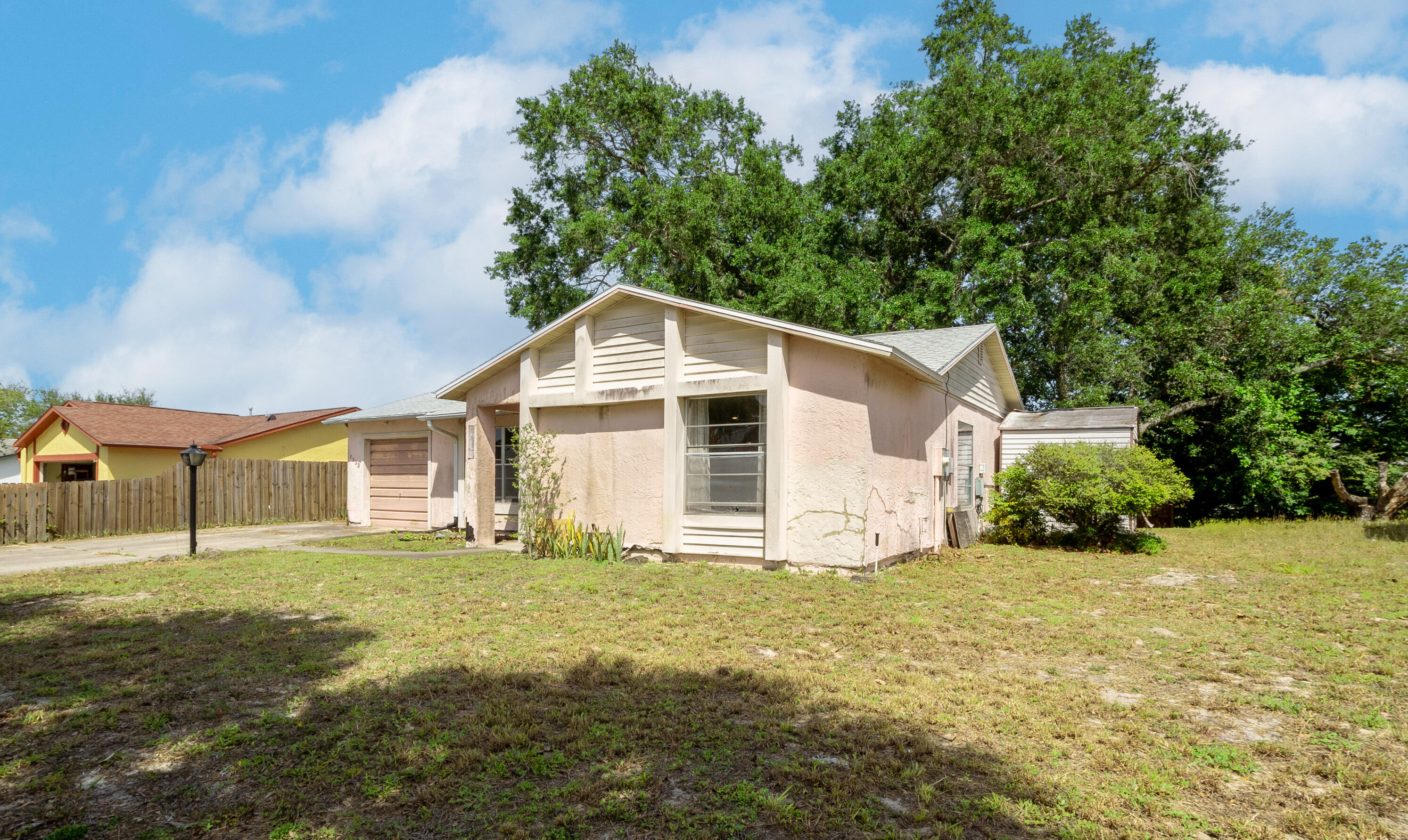 1533 West Powder Horn Road Titusville, FL 32796 - Photo 3 of 29 a front view of a house with a yard