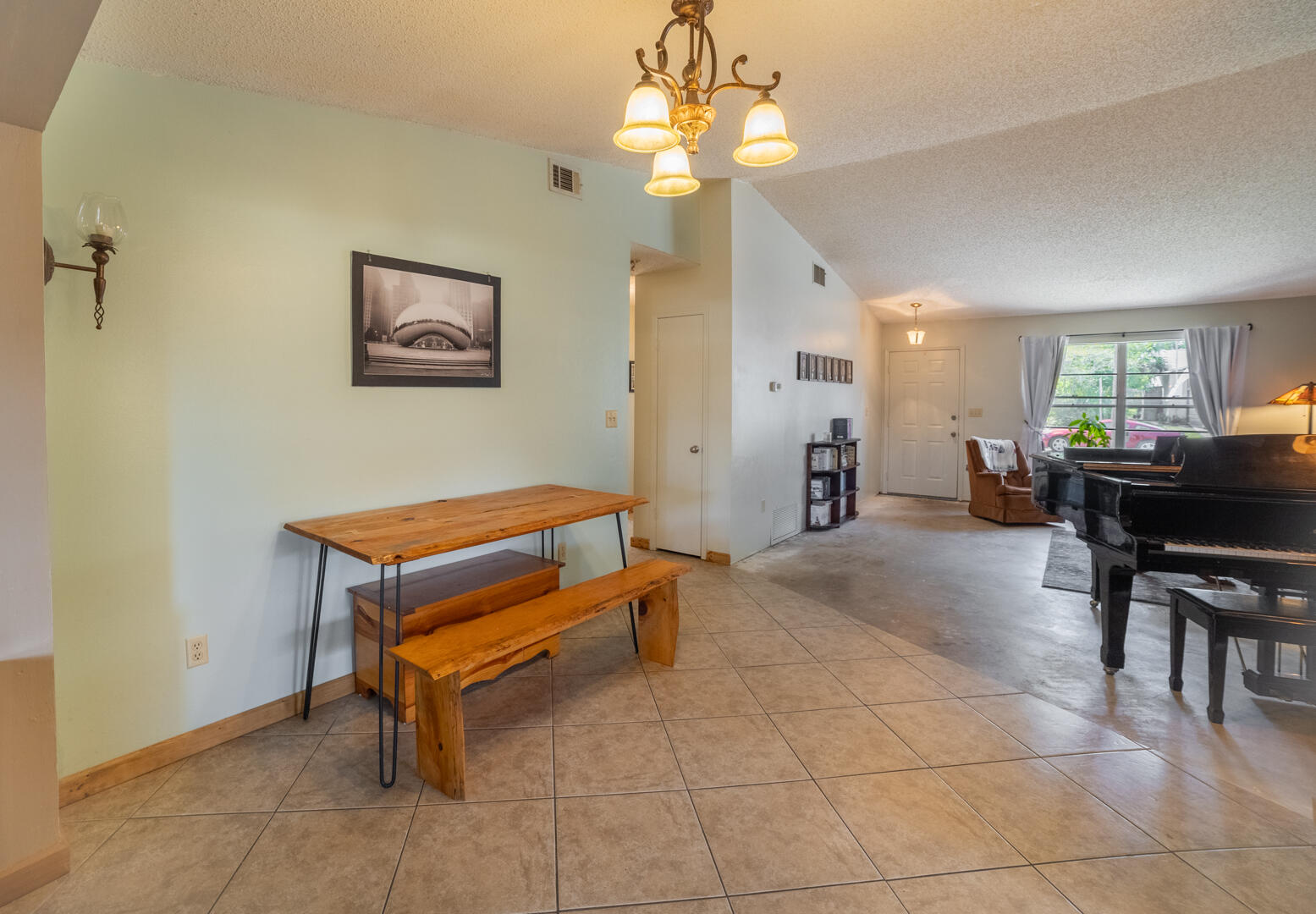 1533 West Powder Horn Road Titusville, FL 32796 - Photo 6 of 29 a living room with a table chairs and a refrigerator