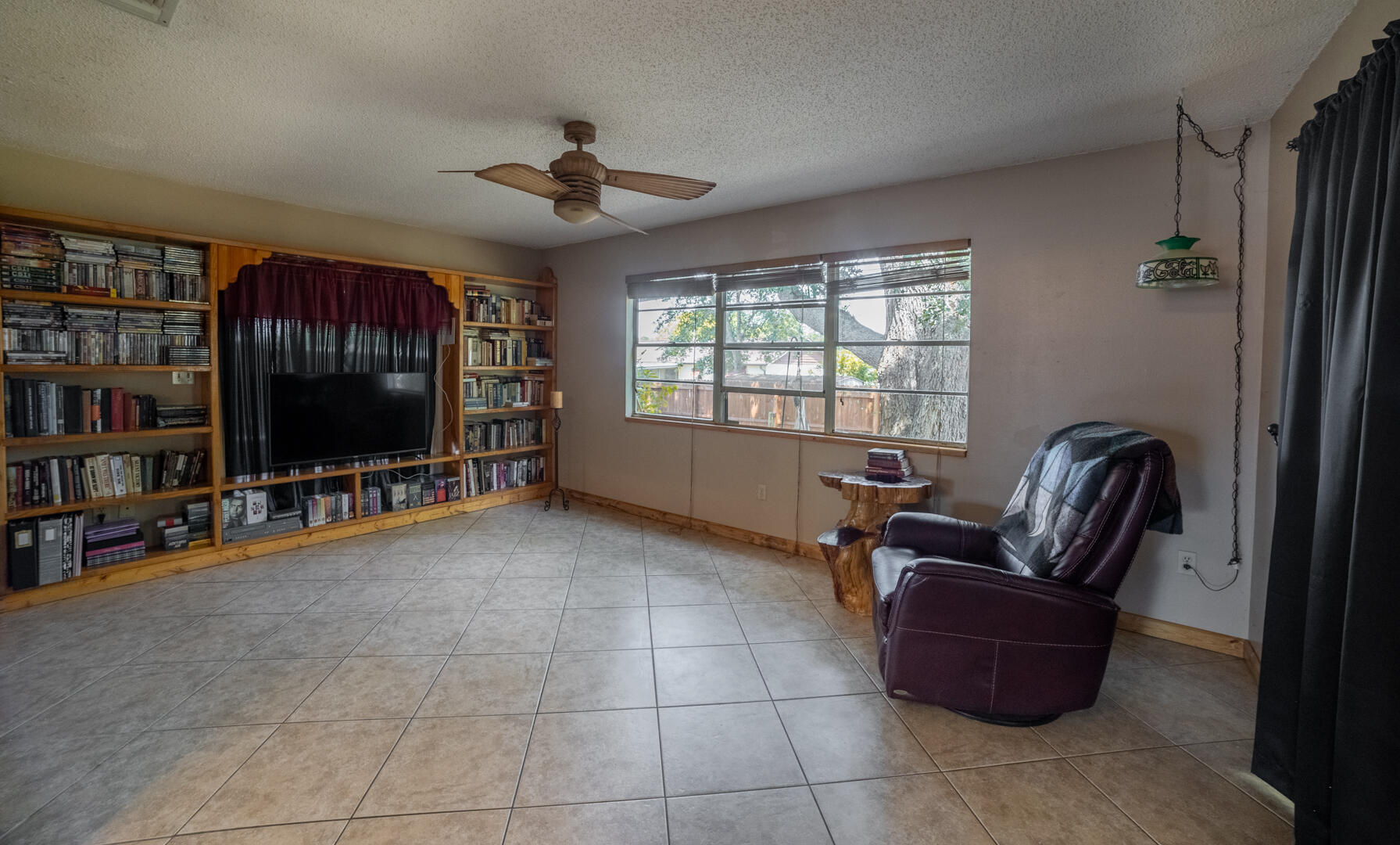 1533 West Powder Horn Road Titusville, FL 32796 - Photo 8 of 29 a living room with furniture and a flat screen tv