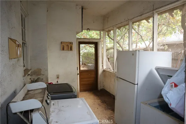 a view of a yard with large tree and wooden fence