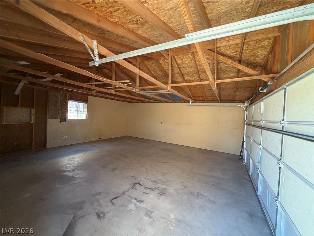 4360 Retread Road Pahrump, NV 89048 - Photo 14 of 19 Exposed wood rafters and a durable concrete floor define this versatile storage space.