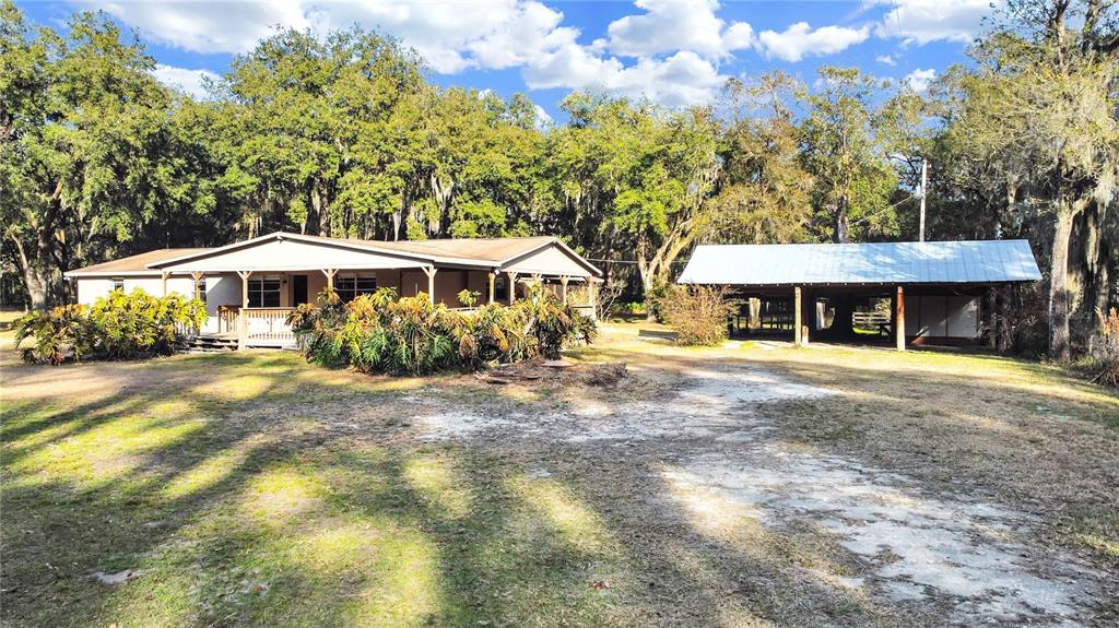 11984 Neal Road Lithia, FL 33547 - Photo 1 of 1 a front view of a house with yard and green space