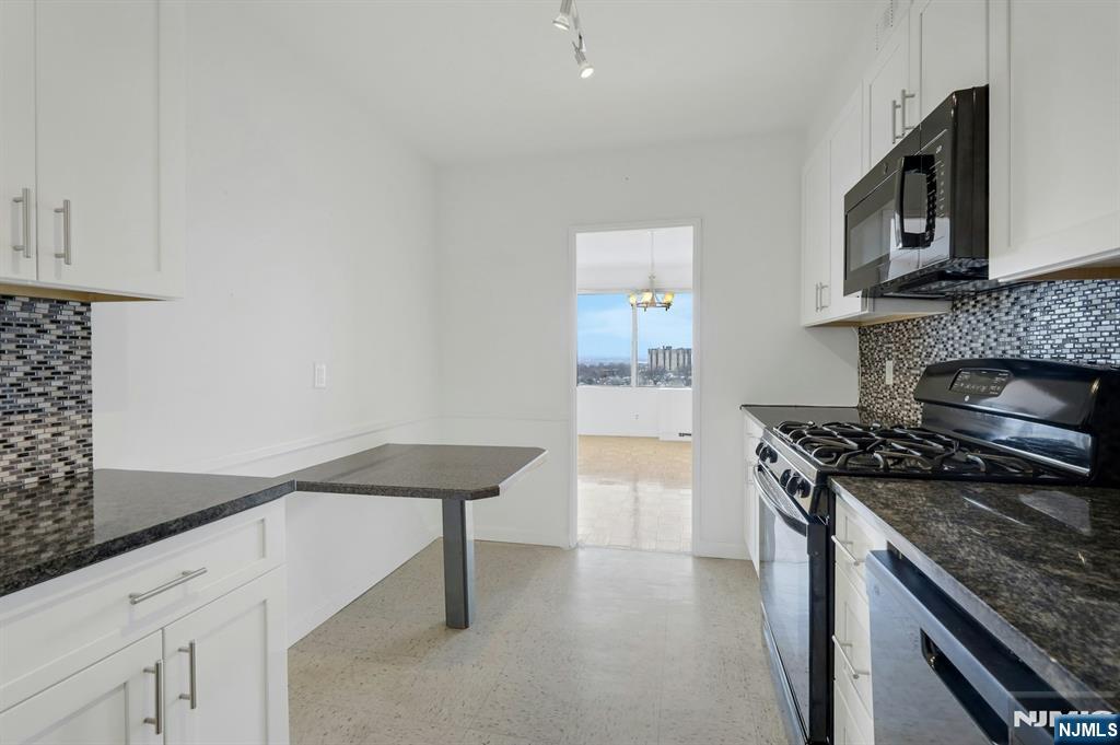 6 Horizon Road, Unit 1508 Fort Lee, NJ 07024 - Photo 29 of 46 a kitchen with cabinets and appliances