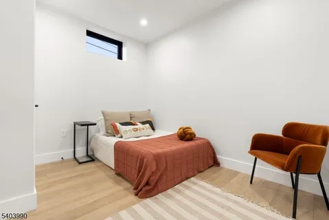 a bedroom with a bed and blue chair