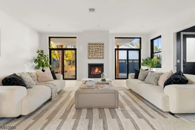 a living room with furniture fireplace and a large window