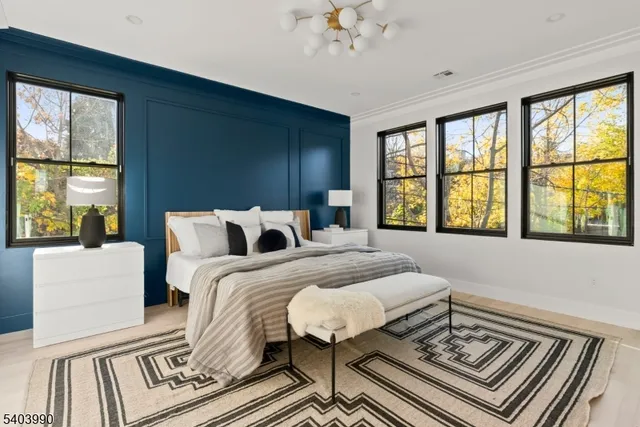 a spacious bedroom with a bed and a large window