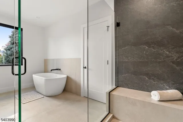 a bathroom with a bathtub and shower