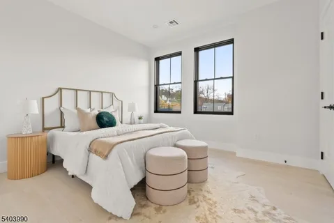 a spacious bedroom with a bed and window