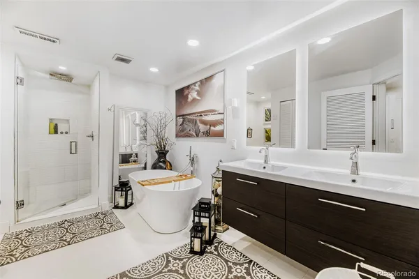 a view of a patio with couches table and chairs with wooden floor and fence