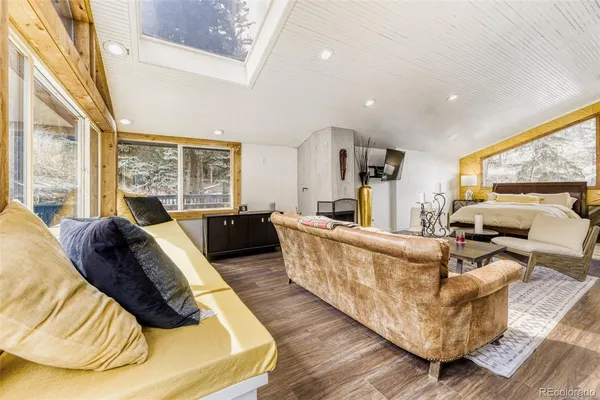 a view of a balcony with chairs and wooden floor