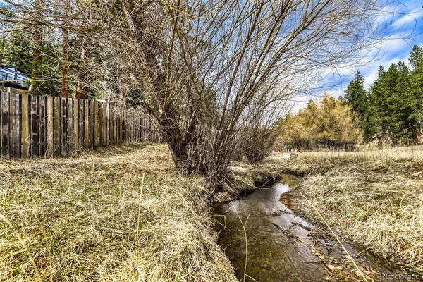 a very nice looking kitchen with a large window wooden floor and stainless steel appliances